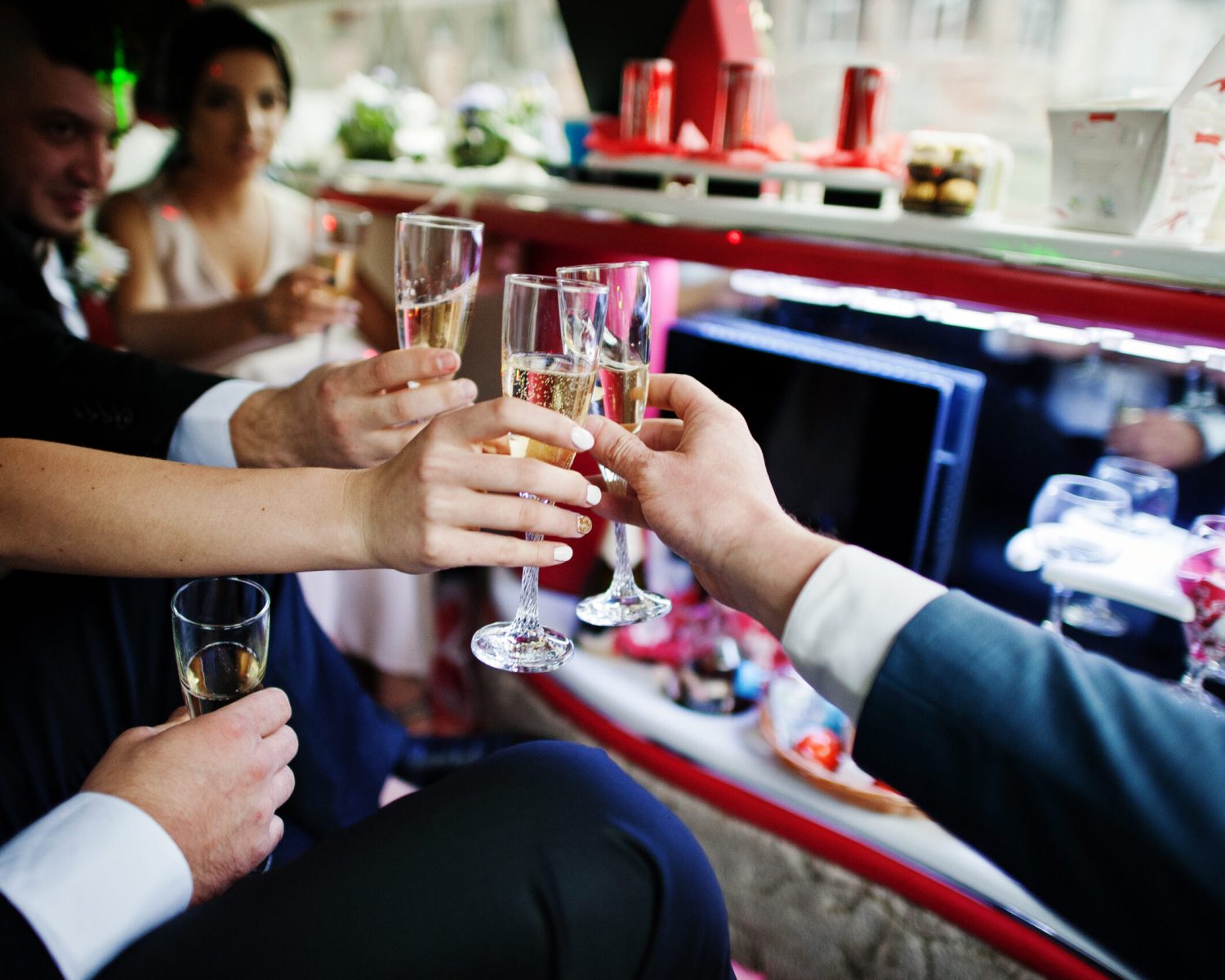 Groomsmen,And,Bridesmaids,Drinking,Champagne,In,The,Limo.